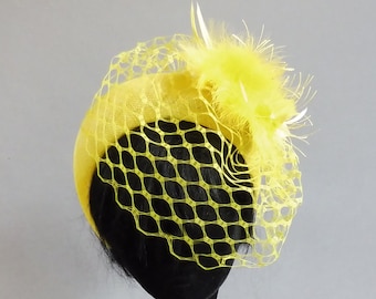 Made with passion this yello halo hat sinamay with ton sur ton feathers and with included but optional birdcage veil