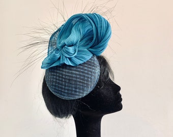 Sinamay percher hat embellished with silk abaca and burned feathers in sea blue and black on comb