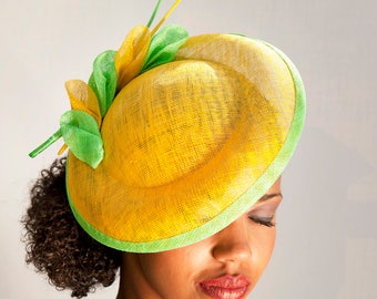 Yellow-green saucerhat, sinamay with ton sur ton feathers on aliceband