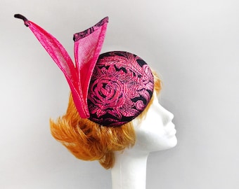 Made with passion black and magenta percher hat sinamay covered with 3d fabric on comb