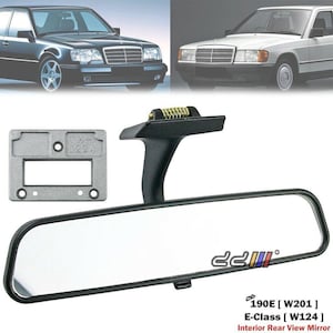 May include: Black interior rear view mirror with a rectangular frame and a reflective surface. The mirror is designed for 190E (W201) and E-Class (W124) vehicles. A small, silver-coloured mounting bracket is also included.