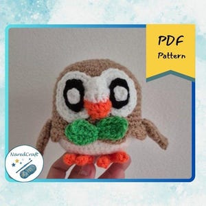 May include: A crocheted owl with brown, white, orange, and green details. The owl has large black eyes, an orange beak, and a green bow tie. The image includes the text "PDF Pattern" and a logo with the text "NaredCraft".