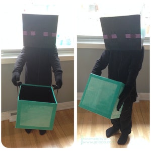 May include: A child wearing a black Minecraft Creeper costume holds a teal box. The costume is made of cardboard and features a black hooded robe and a square head with purple eyes.