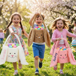 May include: Three children running outdoors, each holding a plush Easter basket shaped like a bunny. The baskets are white, brown, and pink, filled with colorful eggs. The baskets are personalized with names.