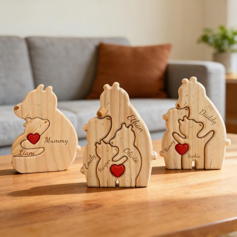 May include: Three light-colored wooden bear figurines featuring engraved names and red heart accents. The first bear is labeled Mummy and Liam, the second features Emily, Harper, and Olivia, and the third displays Daddy, Mummy, and Sophia.