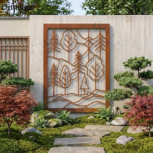 May include: A rectangular, rust-coloured metal garden screen with a cut-out forest design. The screen features various tree shapes and mountain silhouettes. The screen is mounted on a concrete wall in a garden setting with lush greenery and stone pathways.