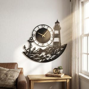 May include: Black metal wall clock featuring a lighthouse, anchor, and waves design. The clock has a circular face with gold-colored hands and a black background. The lighthouse is black and white, and the anchor is detailed.