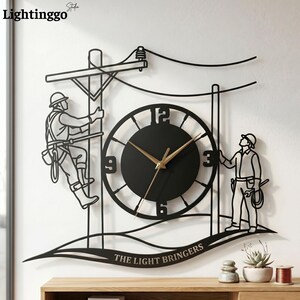 May include: Black metal wall clock featuring a lineman climbing a utility pole and another lineman standing below. The clock has a black face with gold hands and the text "THE LIGHT BRINGERS".