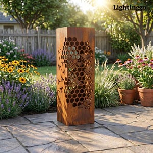 May include: A tall, rectangular, weathered metal garden lantern with a honeycomb and bee design. The lantern is made of rusty brown metal and is placed on a stone patio. The word "Lightinggo" is in the top right corner.