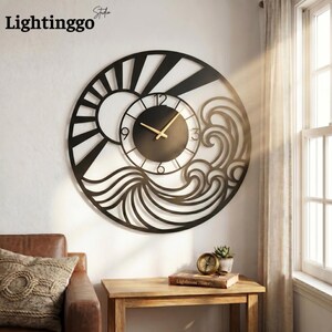 May include: Black metal wall clock with a sun and wave design. The clock face is black with gold-colored hands. The clock is mounted on a white wall. The brand name "Lightinggo Studio" is in the top left corner.