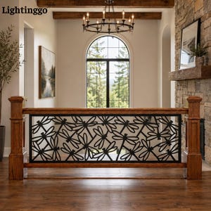 May include: A wooden stair railing featuring a black metal decorative panel with a repeating dragonfly pattern. The railing is constructed with thick, square-profile wooden posts and horizontal rails, framing the intricate metal insert.