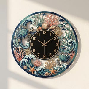 May include: A circular wall clock featuring a black center dial with gold numerals and hands. The frame is decorated with a detailed ocean scene including two sea turtles, coral reefs, seashells, starfish, and waves in shades of blue and gold.