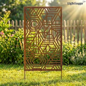 May include: A geometric, rust-coloured metal screen featuring a complex pattern of shapes, including hexagons and triangles. The screen stands on two legs in a grassy garden, with a wooden fence and greenery in the background. The text "Lightinggo" is visible.