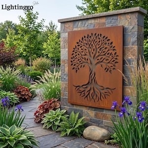 May include: A rectangular metal wall panel with a rust-colored finish featuring a laser-cut design of a tree with intricate branches and roots. The panel is mounted on a stone pillar in a garden setting with various green plants and purple irises.