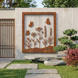 May include: A rectangular, rust-coloured metal wall art piece featuring a cut-out design of flowers and butterflies. The artwork is mounted on a concrete wall, with a garden setting in the background. The piece has a framed border.