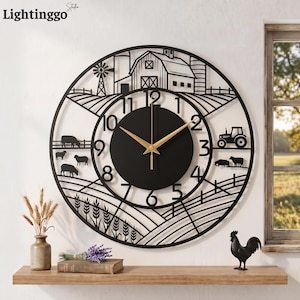 May include: A large circular black metal wall clock featuring a farm scene cutout design. The clock face has gold hands and black numbers from 1 to 12. The intricate metalwork depicts a barn, a windmill, a tractor, sheep, and wheat stalks.
