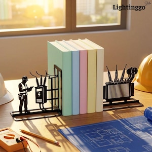 May include: A pair of black metal bookends featuring a silhouette of an electrical worker and a transformer station, supporting a row of five pastel-colored books. The design includes detailed electrical equipment and a worker holding a clipboard.