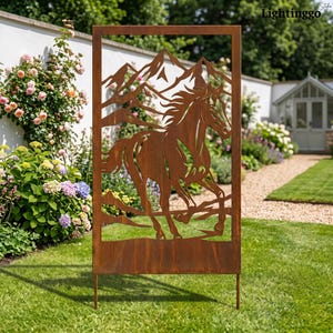 May include: A rectangular metal garden screen with a rust-colored finish featuring a laser-cut design of a galloping horse in the foreground and mountain peaks in the background. The panel is supported by two thin metal stakes at the base.