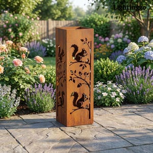 May include: A tall, rectangular, rusty-brown metal garden sculpture. The sculpture features cut-out designs of squirrels on tree branches. The background shows a lush garden with various flowers and greenery, creating a natural setting for the decorative piece.