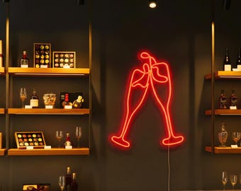 May include: A bright red neon sign depicting two champagne flutes clinking together, mounted on a dark wall between wooden shelves displaying various bottles and gift boxes. The text Lightinggo is visible in the upper left corner.