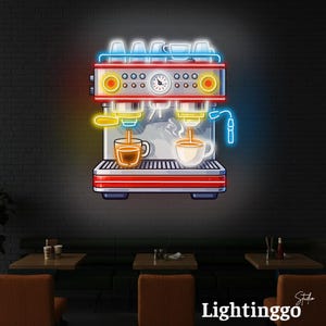 May include: A neon sign depicting a red and silver espresso machine with blue, yellow, and white light accents. The design features two coffee cups being filled, a central pressure gauge, and a row of cups on top, all glowing against a dark wall.