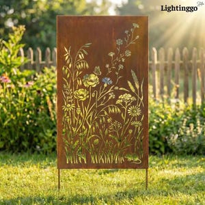 May include: A rectangular, weathered metal garden screen with a cut-out floral design. The screen features various flowers, grasses, and a butterfly, with the text "Lightinggo" at the top. The screen is supported by two metal legs and stands in a grassy area.