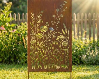 May include: A rectangular, weathered metal garden screen with a cut-out floral design. The screen features various flowers, grasses, and a butterfly, with the text "Lightinggo" at the top. The screen is supported by two metal legs and stands in a grassy area.