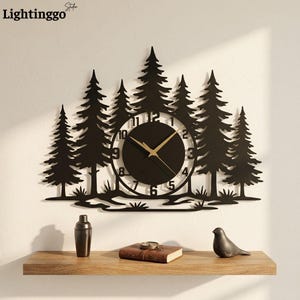 May include: A black wall clock featuring a silhouette of a pine forest. The circular clock face is integrated into the center of the trees and displays black numbers from 1 to 12 with thin gold-colored hour, minute, and second hands.