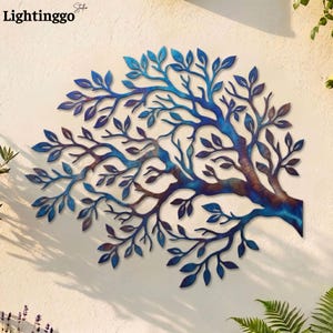 May include: Metal tree wall art in shades of blue and brown. The tree design features intricate branches and leaves, creating a nature-inspired decorative piece. The text "Lightinggo" is in the upper left corner. This artwork is designed to be mounted on a wall.