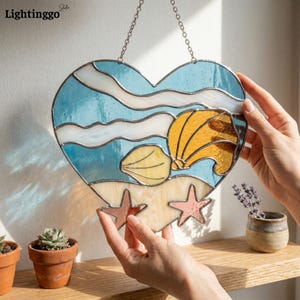 May include: A white ceramic mug with a black handle and the text "But First, Coffee" in a handwritten style. The mug is on a white surface. The mug is approximately 4 inches tall.