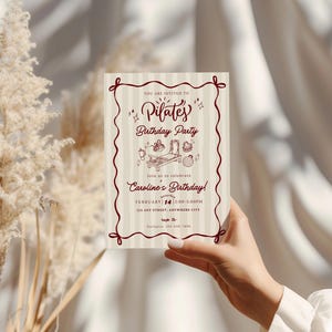 A soft and elegant Pilates birthday invitation featuring hand-drawn Pilates reformer illustrations, Pilates accessories, and minimal line art in a neutral beige and deep red color palette. This editable Pilates birthday party invitation template is designed with subtle stripes, a whimsical border, and modern script typography, perfect for a Pilates-themed birthday celebration or fitness party.