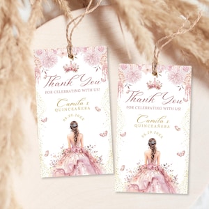 A pink quinceañera favor tag template with watercolor floral accents, elegant lettering, and feminine design. Features a girl in a pink floral gown with a rear view illustration and a crown at the top of the favor tag. Editable digital poster for Mis Quince Años or Sweet 15 party decoration.