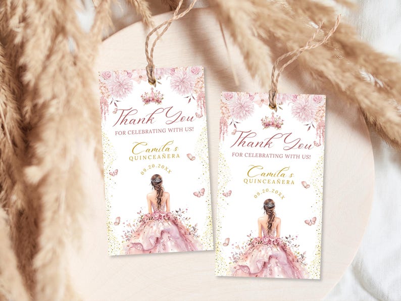 A pink quinceañera favor tag template with watercolor floral accents, elegant lettering, and feminine design. Features a girl in a pink floral gown with a rear view illustration and a crown at the top of the favor tag. Editable digital poster for Mis Quince Años or Sweet 15 party decoration.