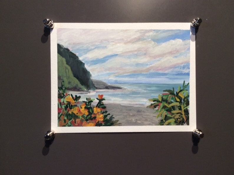 May include: A painting of a seascape with a green hillside, a sandy beach, and blue water. The sky is cloudy and light blue. There are orange and yellow flowers in the foreground.
