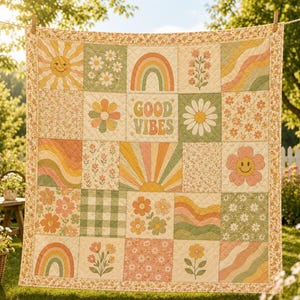 May include: A quilted blanket featuring a patchwork design of squares with floral patterns, rainbows, suns, wavy lines, and a smiley face flower. The center square displays the text GOOD VIBES in a retro font. The quilt has a floral border.