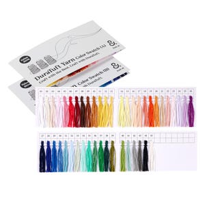 May include: Color swatches of DuraTuft Yarn in a variety of colors, including white, pink, red, brown, yellow, orange, green, blue, and purple. The swatches are arranged in rows with corresponding numbers. The cards read "DuraTuft Yarn Color Swatch".