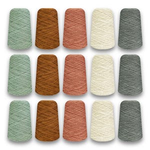 May include: A collection of fifteen yarn cones in various colors, including shades of green, brown, peach, cream, and gray. The cones are arranged in three rows of five, showcasing the different hues and textures of the yarn.