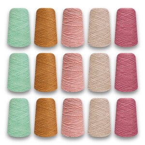 May include: Fifteen spools of yarn in various colors, including mint green, golden brown, light pink, beige, and rose. The yarn is tightly wound on conical spools, suitable for knitting or crocheting projects.