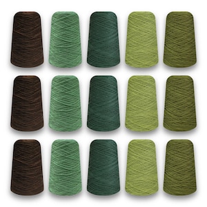 May include: Fifteen spools of yarn in shades of brown, green, and olive. The yarn is wound on conical spools, with five spools each of brown, medium green, dark green, light green, and olive green. The spools are arranged in three rows of five.