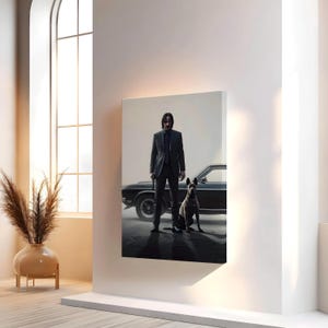 May include: A framed canvas print depicting a man in a dark suit, holding a gun, alongside a classic black car and a dog. The image has a cinematic style with a neutral backdrop.