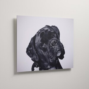 May include: A black and white wall art print featuring a portrait of a Boxer dog. The dog is shown from the chest up, facing forward with a focused expression. The background is a solid, light gray color, highlighting the dog's dark features.