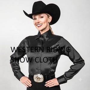 May include: A black long-sleeved button-down shirt with a subtle sheen, paired with a black cowboy hat and a large silver-toned belt buckle featuring a horse motif. The text WESTERN RIDING SHOW CLOTH is overlaid on the center of the shirt.