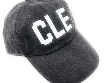 Custom Embroidered CLE Cleveland Hopkins International Airport Code Baseball Hat (Pigment Dyed Black with White Letters)