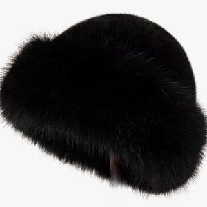 May include: A black fur hat with a wide brim. The hat is made of soft, fluffy fur and has a simple, classic design.
