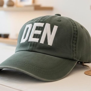 Custom Embroidered DEN Denver International Airport Code Baseball Hat Spruce Green White Letters