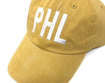 Custom Embroidered PHL Philadelphia International Airport Code Baseball Hat  (Pigment Dyed Mustard with White Letters)