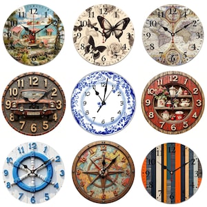 May include: Nine decorative wall clocks with various designs. The clocks feature images of a camper, butterflies, a world map, a vintage car, blue and white china, a tea set, a ship's wheel, a compass, and vertical wood planks. Each clock has black hands.