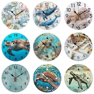 May include: Nine round wall clocks with various marine life designs. The clocks feature images of sea turtles, whales, starfish, and seashells. Each clock has black hands and white numerals. The clock faces are in shades of blue, green, and beige.