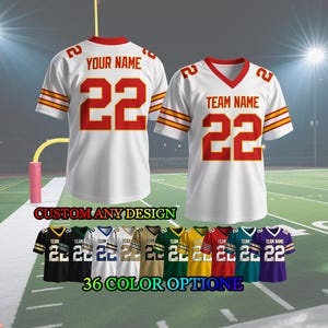 May include: White football jersey with red detailing, displaying the number 22 and either "YOUR NAME" or "TEAM NAME". The jersey has gold stripes on the sleeves. The image also shows 36 colour options for customisation. The text "CUSTOM ANY DESIGN" and "36 COLOR OPTION" are also visible.