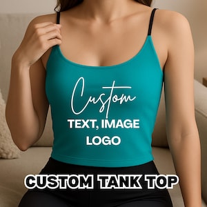 May include: Teal custom tank top with black spaghetti straps. The top features the word "Custom" in a white script font, along with "TEXT, IMAGE, LOGO" in a sans-serif font. The words "CUSTOM TANK TOP" are at the bottom of the image.